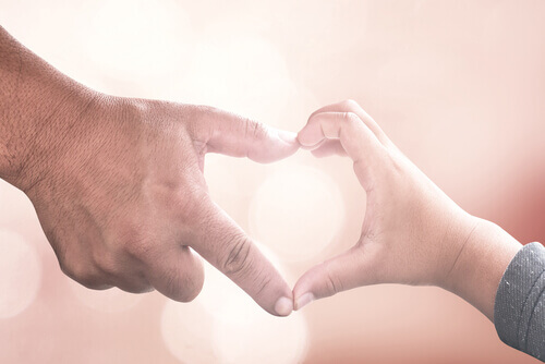 mains d'enfant et parent formant un coeur