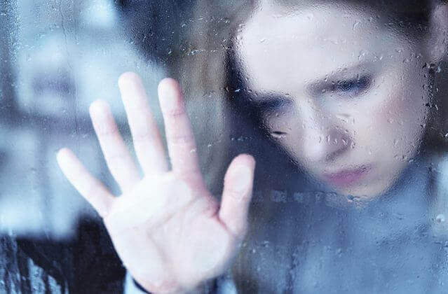 femme regardant par la fenêtre