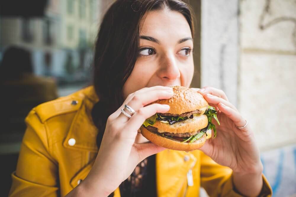 femme mangeant un hamburger