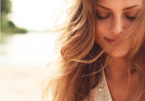 une femme souriante qui regarde vers le bas
