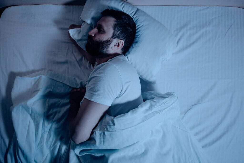 Un homme qui tente de dormir dans son lit. 